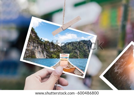 White Photo in hand in selective focus with concept travel Thailand.