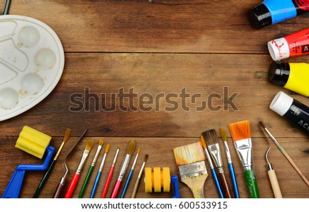 Arts and craft tools on wooden surface