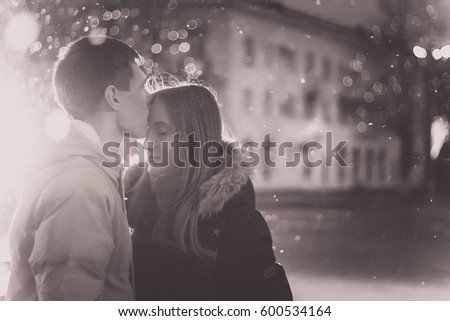 Close-up image of couple in love, man  kisses a woman. Used filters instagram Black-white photo.