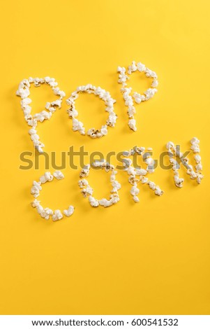 Top view of Pop corn lettering  made from popcorn kernels isolated on yellow