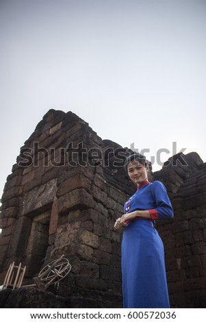 portrait of asian woman wear traditional dress in old public temple, History of Thai concept. 