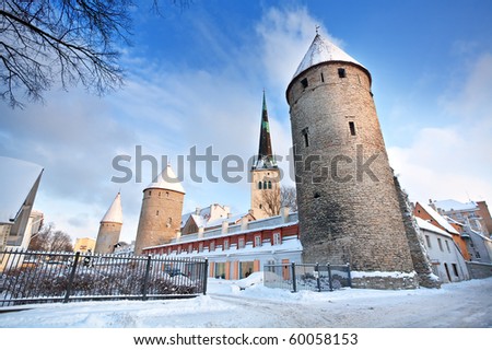 Winter architectural landscape with a historical fortress and  church on sky background