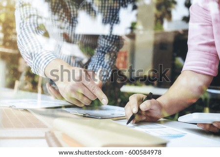 Sales team discussion process.Business crew working with new startup project.Notebook tablet wood table using devices.Creative Idea presentation.Analyze market stock.Blurred background film effect.