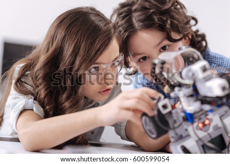 Inventive kids enjoying science lesson at school Royalty-Free Stock Photo #600599054