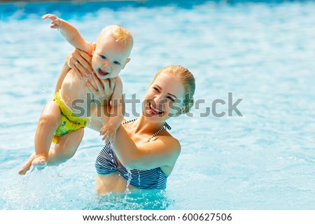 Mother and baby swim  in the pool
