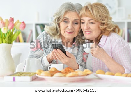 Two beautiful mature women having breakfast