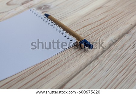 Vintage style of open notebook and pen on the old wooden floor