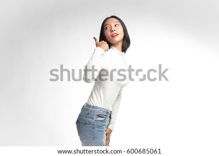 Beautiful asian girl  giving thumb up on white background