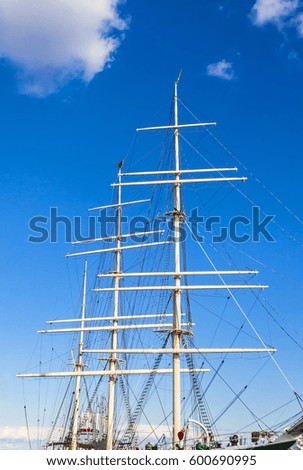 Nautical maritime scene with ropes and masts on a ship in a dock