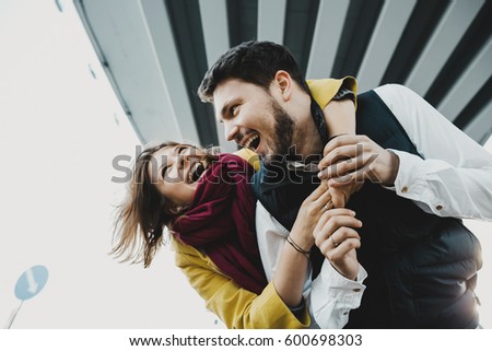 Bearded man and woman have fun posing under the bridge Royalty-Free Stock Photo #600698303