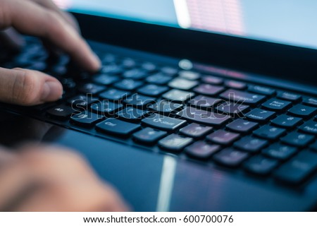 Russian hacker hacking the server in the dark Royalty-Free Stock Photo #600700076