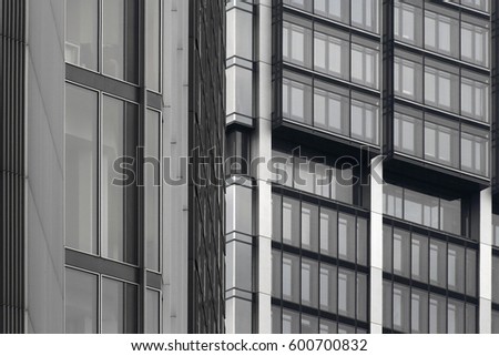 Tilt photo of office building midsection. Abstract black and white image on the subject of modern architecture and commercial real estate.