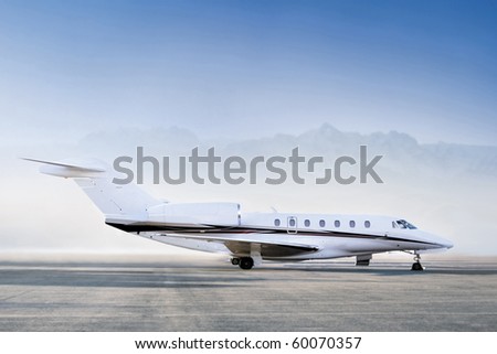 Private jet airplane standing on airfield ready to take off. Business and power concept. Early morning time Royalty-Free Stock Photo #60070357