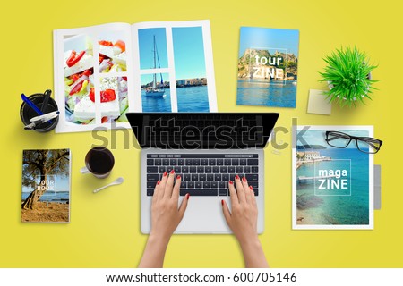 Travel reporter, journalist write blog or newspaper article on laptop computer. Magazines beside. Top view of work desk. Royalty-Free Stock Photo #600705146