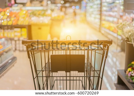 Abstract blurred photo of trolley in department store bokeh background,empty shopping cart in supermarket ,vintage color