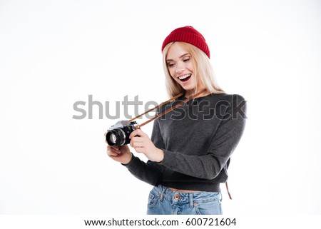 Happy pretty girl with mouth opened holding old vintage camera isolated on a white background
