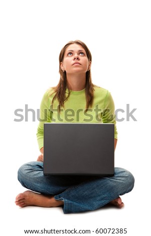 Yong woman sitting on  floor with laptop and looks upwards, isolated over white