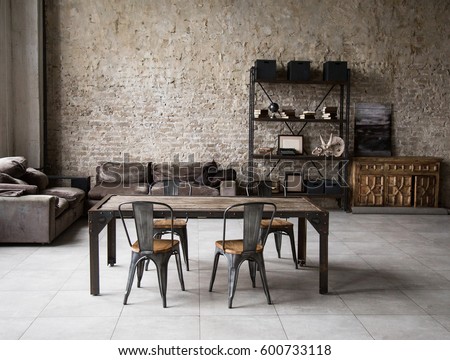 Modern loft living room with high ceiling, sofa, empty brown brick wall, concrete floor, wooden cabinet, design accessories in the steel stack, dining table with chairs. Mock up interior photo Royalty-Free Stock Photo #600733118