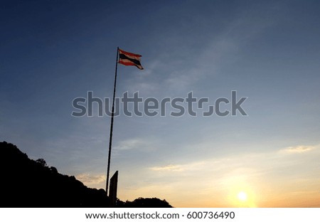 Waving Thai flag with sunrise view