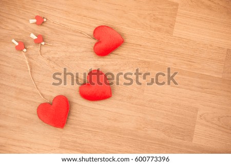 gingham love valentine hearts natural cord and red clips hanging on wood background