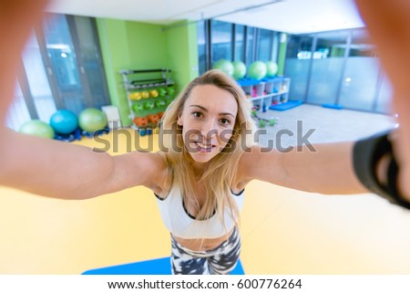 sport woman smile at camera self picture at gym, young girl picture herself exercising fitness center