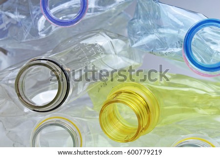 Plastic bottle texture. Illustration of pollution industry or any other concept. Close-up shot of stack of recyclable plastic bottles on white studio background.