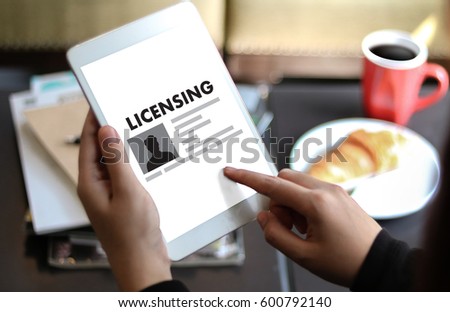 Patent License agreement LICENSING   business man hand working on laptop computer