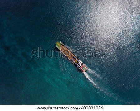 Aerial shot of the cargo ship moving in the sea