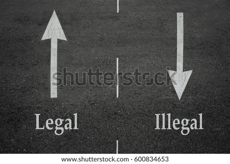 Opposite arrow on the asphalt road with text legal and illegal.