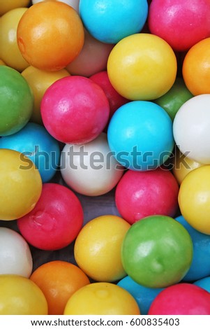 Bubble gum chewing gum texture. Rainbow multicolored bubblegum balls chewing gums as background. Round sugar coated retro bubblegum texture.  Colorful bubblegums wallpaper.