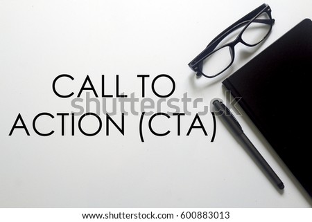 A glasses, notebook and pen with CALL TO ACTION written on white background. A business concept.