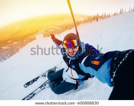 guy sportsman goes on the normal skiing on the ski slope with the action camera. Sunset. Sheregesh, Kemerovo region, Russia.