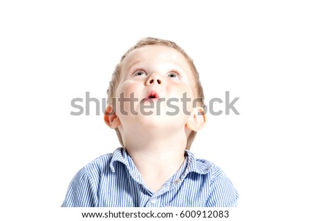 Very cute surprised little boy, isolated. Large copy-space. Cute boy face in astonishment and looking up, isolated over white