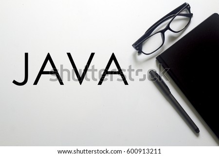 A business concept. A glasses, pen and notebook with JAVA written on white background.