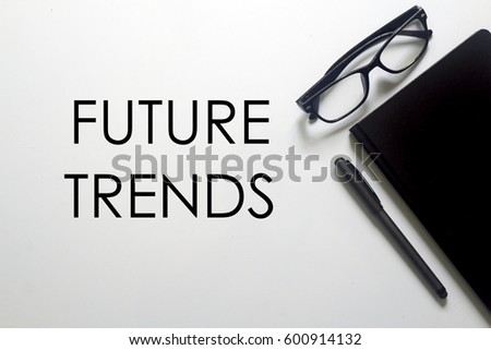 A business concept. A glasses, pen and notebook with FUTURE TRENDS written on white background.