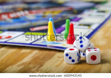 Cubes with the game monopoly on the table Royalty-Free Stock Photo #600943145