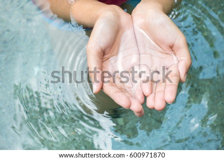 Clear natural water in woman hands. Royalty-Free Stock Photo #600971870