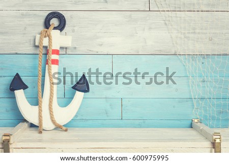 Anchor against the background of blue-white boards