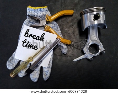 conceptual images of tools/glove/piston assembly and word-break time with black board/low light/vintage/selective focus