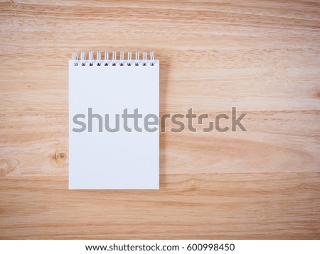 Notepad on the wooden desk table