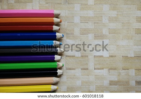 coloured pencils or crayon on the wood background