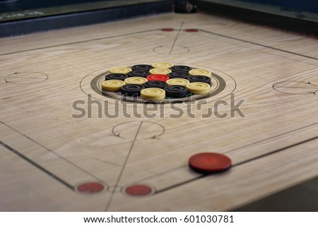 A game of carrom with pieces carrom man on the board carrom - focus of part