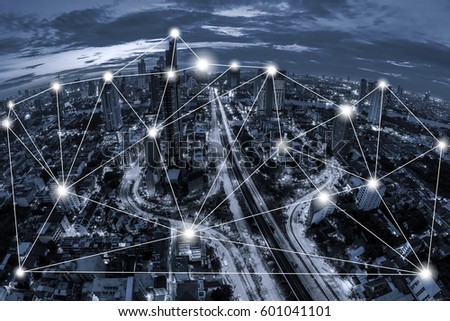 Network conection concept on blue tone Aerial view of cityscape Bangkok business district background.