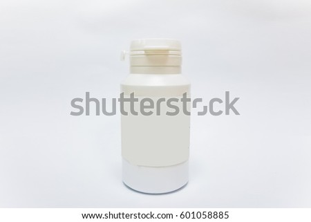 white plastic medicine bottle with blank label isolated on white background