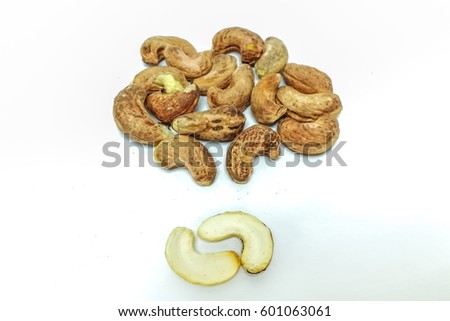 pile of roasted cashews nut with shell separate with crack piece isolated on white background