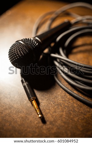 Close up shot of a microphone and some cables.
