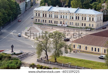 Aerial view of Viborg city Russia: buildings. street. green trees. monument; transport in summer