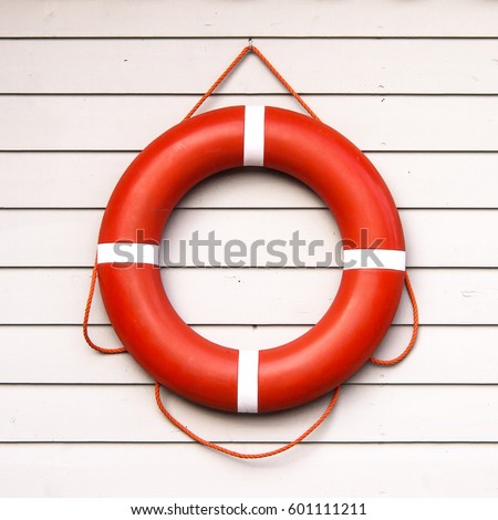 life belt, rescue ring on wooden wall Royalty-Free Stock Photo #601111211