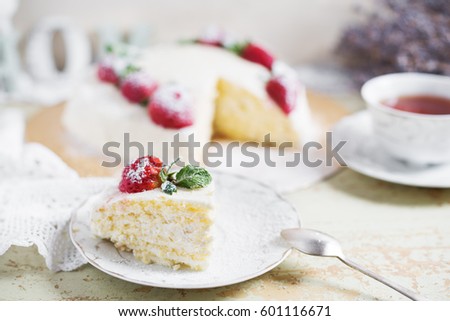 beautiful cake with strawberries and cream. wooden background. Selective focus.