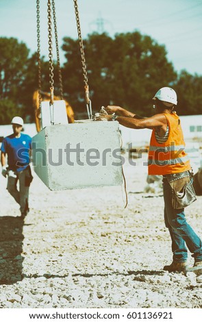 Workers operating in contruction building site.
